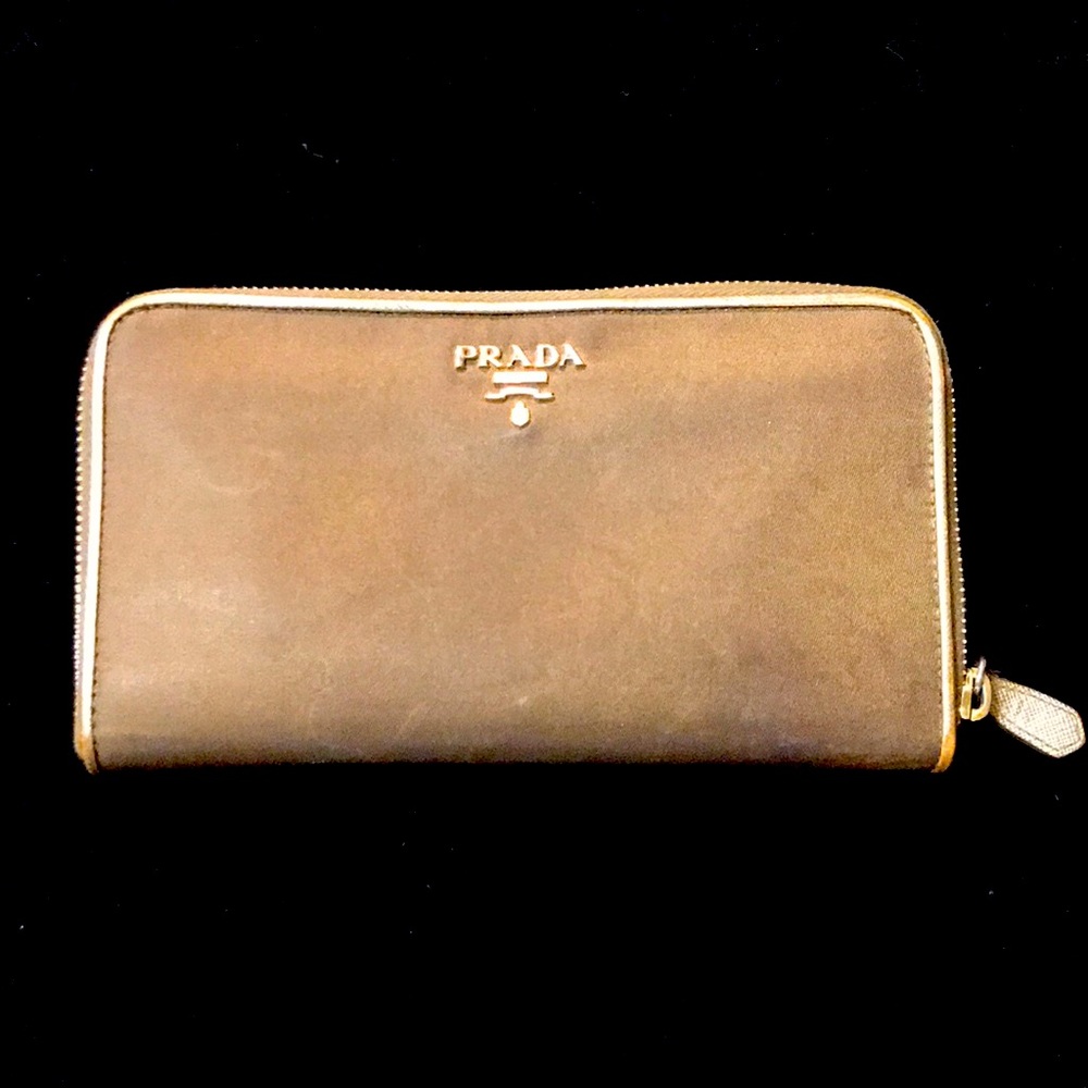 Prada wallet brown with gold trim.